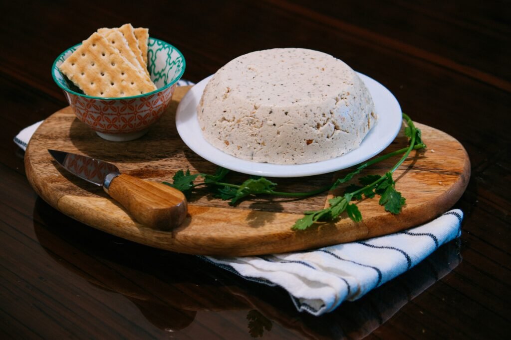 a bowl of crackers and a plate of food on a table